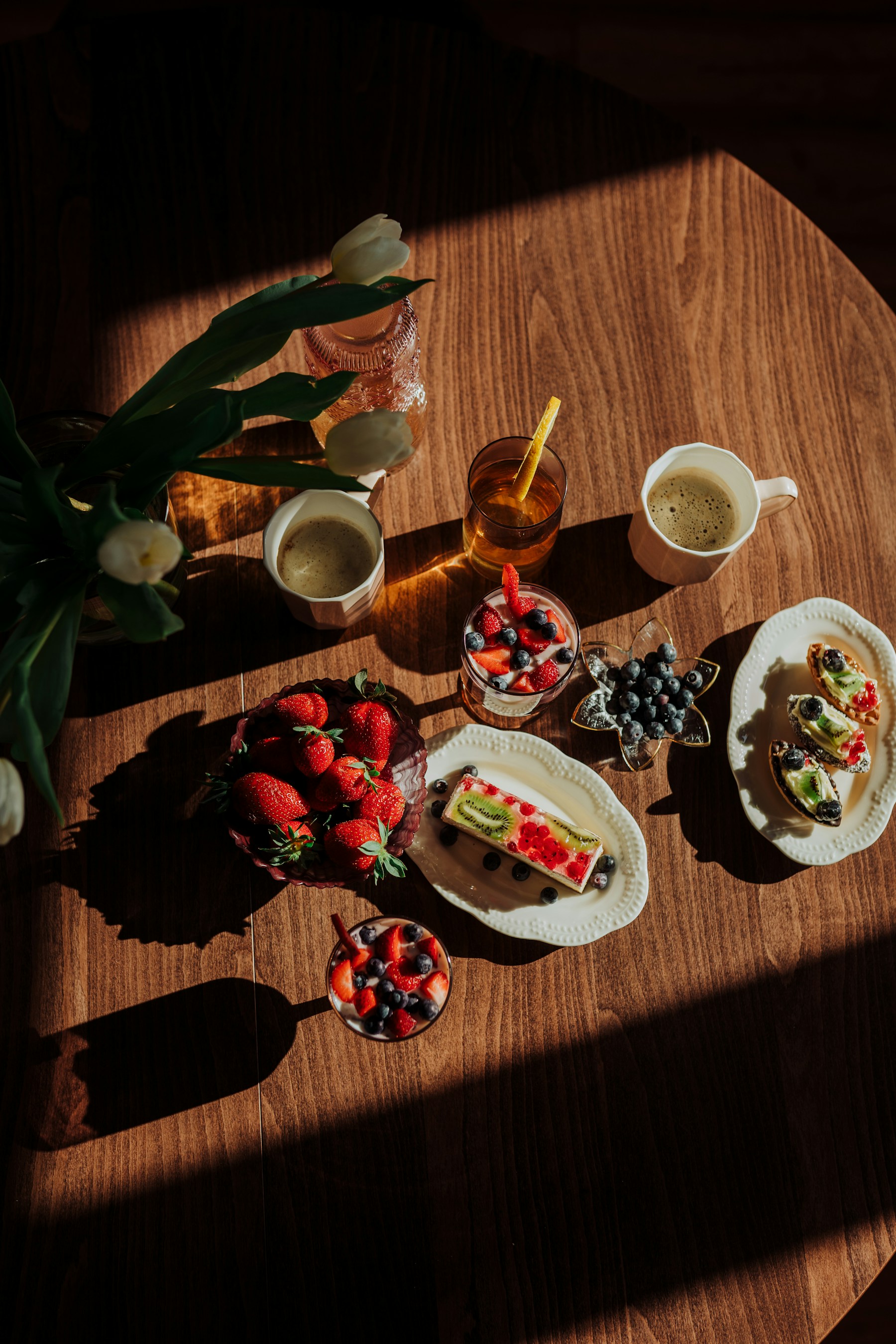 Breakfast table with coffee, fruit, and morning light